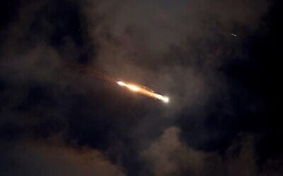Missile trails are seen in the sky above Netanya amid an Iranian missile attack on June 21, 2025 (JACK GUEZ / AFP)