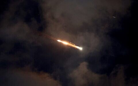 Missile trails are seen in the sky above Netanya amid an Iranian missile attack on June 21, 2025 (JACK GUEZ / AFP)