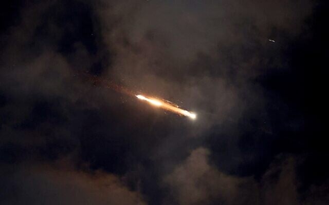 Missile trails are seen in the sky above Netanya amid an Iranian missile attack on June 21, 2025 (JACK GUEZ / AFP)