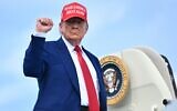 US President Donald Trump pumps his fist as he boards Air Force One at Morristown Municipal Airport in Morristown, New Jersey, on June 21, 2025, as he returns to the White House from his golf club in Bedminster, New Jersey. (Mandel Ngan/AFP)