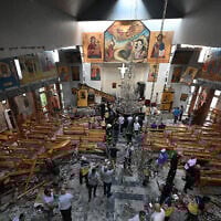 People and rescuers inspect the damage at the site of a reported suicide attack at the Saint Elias church in Damascus's Dwelaa area on June 22, 2025. (LOUAI BESHARA / AFP)