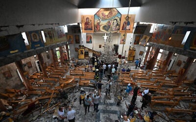 People and rescuers inspect the damage at the site of a reported suicide attack at the Saint Elias church in Damascus's Dwelaa area on June 22, 2025. (LOUAI BESHARA / AFP)