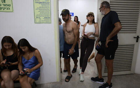 People gather in a underground shelter in Tel Aviv on June 23, 2025, after sirens sounded in several areas across the country after missiles were fired from Iran (Menahem Kahana / AFP)