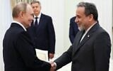 Russia's President Vladimir Putin, left, and Iranian Foreign Minister Abbas Araghchi shake hands during a meeting at the Kremlin in Moscow on June 23, 2025. (Alexander KAZAKOV / POOL / AFP)