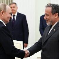 Russia's President Vladimir Putin, left, and Iranian Foreign Minister Abbas Araghchi shake hands during a meeting at the Kremlin in Moscow on June 23, 2025. (Alexander KAZAKOV / POOL / AFP)