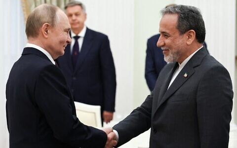 Russia's President Vladimir Putin, left, and Iranian Foreign Minister Abbas Araghchi shake hands during a meeting at the Kremlin in Moscow on June 23, 2025. (Alexander KAZAKOV / POOL / AFP)