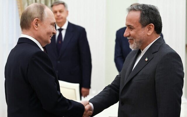 Russia's President Vladimir Putin, left, and Iranian Foreign Minister Abbas Araghchi shake hands during a meeting at the Kremlin in Moscow on June 23, 2025. (Alexander KAZAKOV / POOL / AFP)