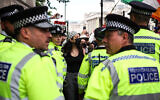 Illustrative: Metropolitan police stand in front of protesters at an anti-Israel, pro-Palestinian demonstration in support of the group Palestine Action as the UK government gears up to ban it, in Trafalgar Square, central London, Great Britain, June 23, 2025. (HENRY NICHOLLS / AFP)