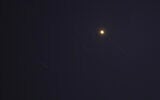 Projectiles are pictured in the sky over the Qatari capital of Doha on June 23, 2025, as Iran launched missiles at a US military base in Qatar. (AFP)