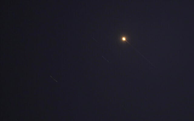 Projectiles are pictured in the sky over the Qatari capital of Doha on June 23, 2025, as Iran launched missiles at a US military base in Qatar. (AFP)