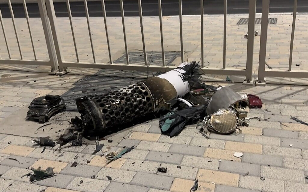 This frame grab take from AFPTV footage shows the remnants of an Iranian missile intercepted over Qatar, as it lies on a pavement near a fence on June 23, 2025. (Photo by AFPTV / AFP)