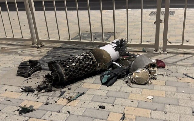 This frame grab take from AFPTV footage shows the remnants of an Iranian missile intercepted over Qatar, as it lies on a pavement near a fence on June 23, 2025. (Photo by AFPTV / AFP)