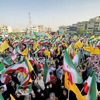 Iranians wave national flags and chant slogans as they celebrate a ceasefire between Iran and Israel at Enghlab Square in the capital Tehran on June 24, 2025. (ATTA KENARE / AFP)
