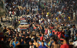 Palestinians gather at an aid distribution point set up by the Gaza Humanitarian Foundation (GHF), near the Nuseirat refugee camp in the central Gaza Strip on June 25, 2025. (Eyad BABA / AFP)