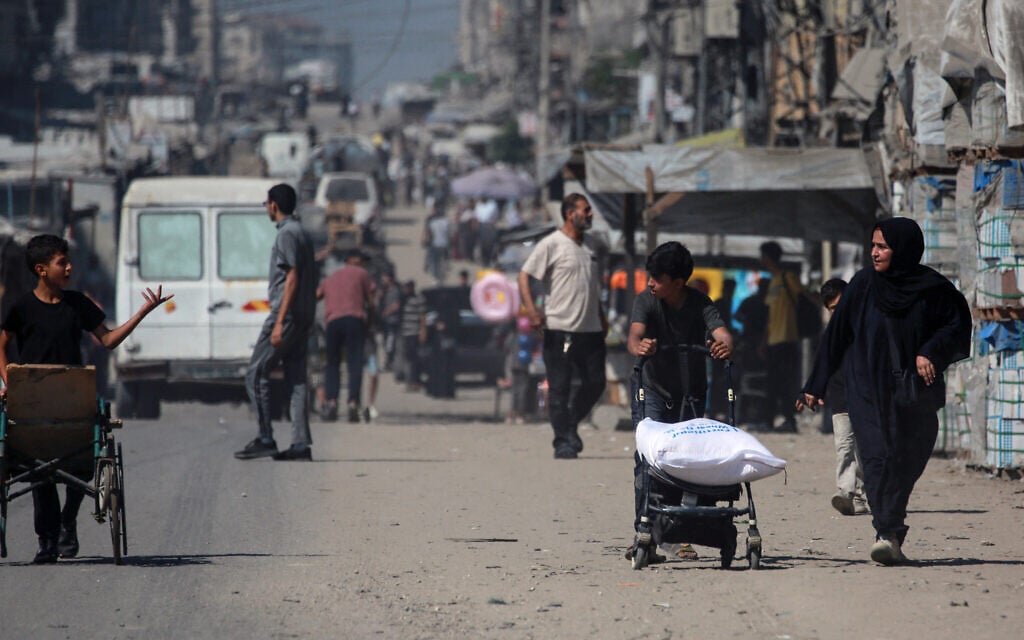 A Palestinian child transports a bag of flour obtained at a distribution point set up by the independent Save Your Future Society (SYFS), in coordination with the UN World Food Programme (WFP), in Gaza City on June 26, 2025. (Bashar TALEB / AFP) A Palestinian child transports a bag of flour obtained at a distribution point set up by the independent Save Your Future Society (SYFS), in coordination with the UN World Food Programme (WFP), in Gaza City on June 26, 2025. (Bashar TALEB / AFP)