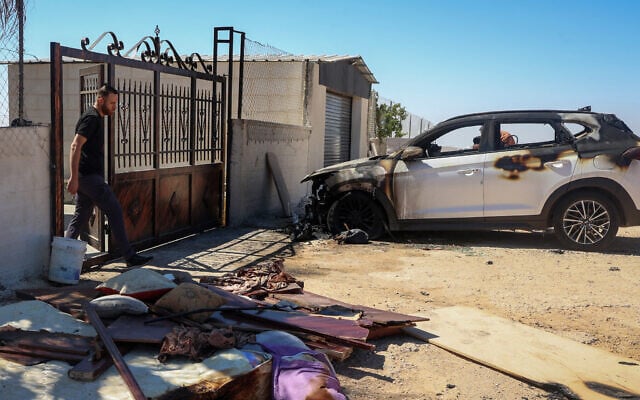 A Palestinian man walks near a burnt car after an Israeli settlers attack the previous day in the village of Kafr Malik in the West Bank, on June 26, 2025. (Photo by Zain JAAFAR / AFP) A Palestinian man walks near a burnt car after an Israeli settlers attack the previous day in the village of Kafr Malik in the West Bank, on June 26, 2025. (Photo by Zain JAAFAR / AFP)
