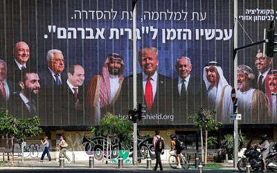 A billboard is displayed in Tel Aviv by the "Coalition for Regional Security," an Israeli political-security initiative, depicting Middle Eastern leaders alongside US President Donald Trump and Prime Minister Benjamin Netanyahu, with a Hebrew slogan calling for a new "Abrahamic Covenant," June 26, 2025. (Jack Guez/AFP)