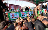 Mourners stand next to the coffin of Iranian Revolutionary Guards commander Amir ali Hjizadeh (L), and other military commanders killed during Israeli strikes on the first day of the war, during their funeral procession at Enqelab Square in the capital Tehran on June 28, 2025 (ATTA KENARE / AFP)