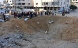 Palestinians gather around a huge crater after an Israeli strike hit the tents of displaced people in the northern Al-Rimal neighborhood of Gaza City on June 28, 2025. (Omar AL-QATTAA / AFP)