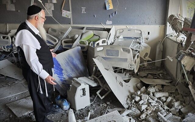 Rabbi Yehuda Mamorstein, CEO and founder of ALEH, stands amid the rubble of the organization's facility in Bnei Brak, following a deadly Iranian missile attack, June 17, 2025. (ALEH)