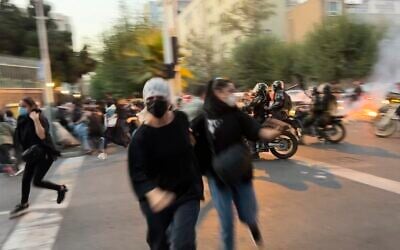 Women run away from anti-riot police during a protest of the death of a young woman who had been detained for violating the country's conservative dress code, on Sept. 19, 2022, in downtown Tehran, Iran. Photo taken by an individual not employed by the Associated Press and obtained by the AP outside Iran. (AP Photo)