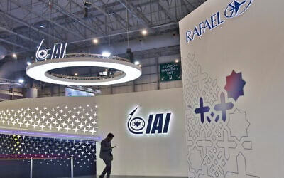 A man walks past the empty stand of Israel Aerospace Industries with an empty Rafael stand seen at the Dubai Air Show in Dubai, United Arab Emirates, Nov. 13, 2023. (AP Photo/Jon Gambrell)