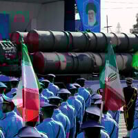A Russian-made S-300 air defense system is carried on a truck in front of a portrait of the Iranian Supreme Leader Ayatollah Ali Khamenei during an annual armed forces parade just outside Tehran, Iran, September 21, 2024. (Vahid Salemi/AP)