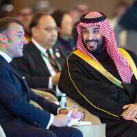 In this photo provided by the Saudi Royal Palace, Saudi's Crown Prince Mohammed bin Salman, talks to French President Emmanuel Macron during the One Water Summit in Riyadh, Saudi Arabia, Tuesday, Dec. 3, 2024. (Bandar Aljaloud/Saudi Royal Palace via AP)