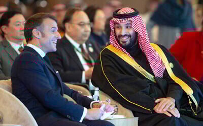In this photo provided by the Saudi Royal Palace, Saudi's Crown Prince Mohammed bin Salman, talks to French President Emmanuel Macron during the One Water Summit in Riyadh, Saudi Arabia, Tuesday, Dec. 3, 2024. (Bandar Aljaloud/Saudi Royal Palace via AP)