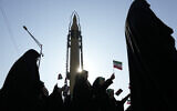 Members of the Iranian Basij paramilitary force march as a domestically built missile is displayed during a parade in Tehran, Iran, Friday, January 10, 2025. (AP/Vahid Salemi)
