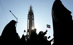 Members of the Iranian Basij paramilitary force march as a domestically built missile is displayed during a parade in Tehran, Iran, Friday, January 10, 2025. (AP/Vahid Salemi)