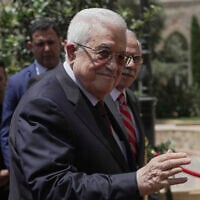 Lebanese Prime Minister Nawaf Salam, right, welcomes Palestinian Authority President Mahmoud Abbas before their meeting at the Government Palace in Beirut, Lebanon, Thursday, May 22, 2025. (AP Photo/Hassan Ammar)