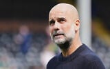 Manchester City's manager Pep Guardiola looks on ahead of the English Premier League soccer match between Fulham and Manchester City at Craven Cottage, London, May 25, 2025. (AP Photo/Dave Shopland)