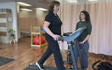 Terri Swain-Collins uses a treadmill in the care of physiotherapist Alison MacDonald on May 20, 2025, at Kingston Injury Management, a clinic in Kingston, Ontario, in Canada. (Lisa Callahan via AP)