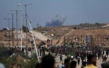 Smoke rises following an Israeli bombardment in southern Gaza, as seen from a humanitarian aid distribution center operated by the US-backed Gaza Humanitarian Foundation on Thursday, May 29, 2025. (AP/Abdel Kareem Hana)