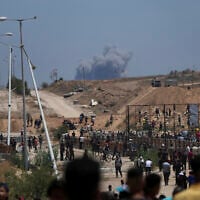 Smoke rises following an Israeli bombardment in southern Gaza, as seen from a humanitarian aid distribution center operated by the US-backed Gaza Humanitarian Foundation on Thursday, May 29, 2025. (AP/Abdel Kareem Hana)
