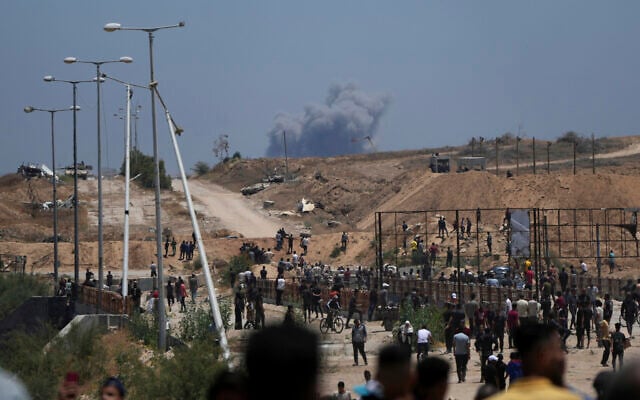 Smoke rises following an Israeli bombardment in southern Gaza, as seen from a humanitarian aid distribution center operated by the US-backed Gaza Humanitarian Foundation on Thursday, May 29, 2025. (AP/Abdel Kareem Hana)