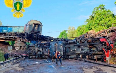 In this photo released by Moscow Interregional Transport Prosecutor's Office telegram channel, an emergency employee works at a damaged bridge after the crash of a freight train in Russia's Kursk region, which borders Ukraine, June 1, 2025. (Moscow Interregional Transport Prosecutor's Office telegram channel via AP)