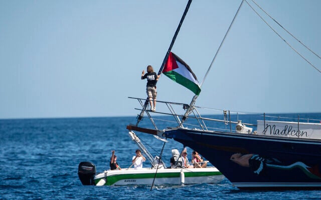 Climate activist Greta Thunberg stands near a Palestinian flag after boarding the Madleen boat and before setting sail for Gaza along with activists of the Freedom Flotilla Coalition, departing from the Sicilian port of Catania, Italy on June 1, 2025. (AP Photo/Salvatore Cavalli) Climate activist Greta Thunberg stands near a Palestinian flag after boarding the Madleen boat and before setting sail for Gaza along with activists of the Freedom Flotilla Coalition, departing from the Sicilian port of Catania, Italy on June 1, 2025. (AP Photo/Salvatore Cavalli)