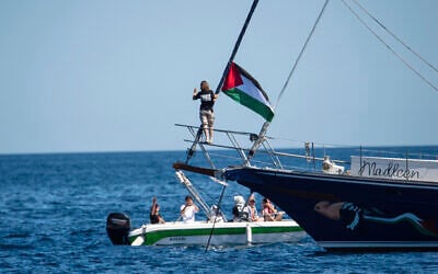 Activist Greta Thunberg stands near a Palestinian flag after boarding the Madleen boat and before setting sail for Gaza along with activists of the Freedom Flotilla Coalition, departing from the Sicilian port of Catania, Italy on June 1, 2025. (AP Photo/Salvatore Cavalli) Activist Greta Thunberg stands near a Palestinian flag after boarding the Madleen boat and before setting sail for Gaza along with activists of the Freedom Flotilla Coalition, departing from the Sicilian port of Catania, Italy on June 1, 2025. (AP Photo/Salvatore Cavalli)