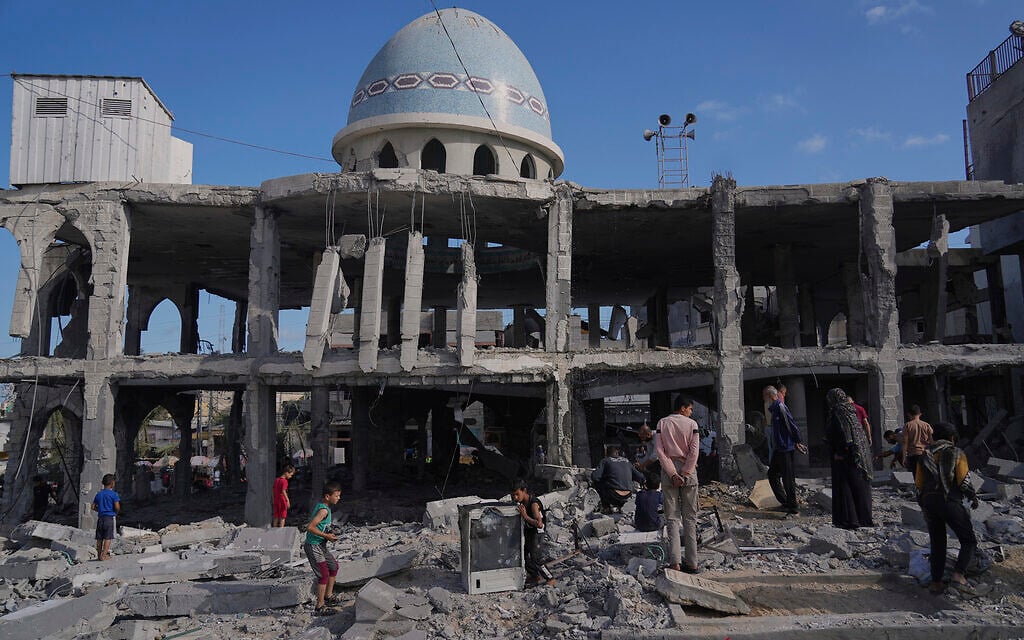 Palestinians inspect the rubble at the Al-Ansar Mosque following an Israeli strike in Deir al-Balah, Gaza Strip, June 2, 2025. (AP Photo/Abdel Kareem Hana)