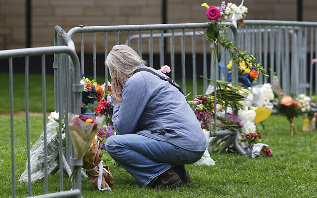 A visitor offers a tribute after leaving a bouquet of flowers at a makeshift memorial for victims of an attack on a demonstration for Israeli hostages, seen outside of the Boulder County, Colorado, courthouse, June 3, 2025. (David Zalubowski/AP) A visitor offers a tribute after leaving a bouquet of flowers at a makeshift memorial for victims of an attack on a demonstration for Israeli hostages, seen outside of the Boulder County, Colorado, courthouse, June 3, 2025. (David Zalubowski/AP)