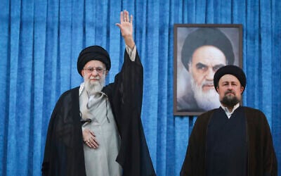 Iranian Supreme Leader Ayatollah Ali Khamenei at a ceremony marking the anniversary of the 1989 death of the late founder of the Islamic Republic, Ayatollah Ruhollah Khomeini, shown in the poster in background, as Ayatollah Khomeini's grandson Hassan stands at right, at his shrine just outside Tehran, Iran, June 4, 2025. (Office of the Iranian Supreme Leader via AP)