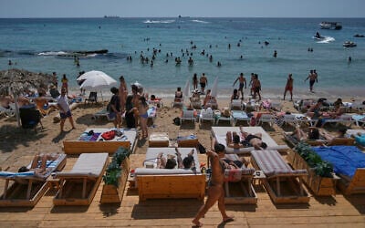 People sunbathe on the beach along the Mediterranean Sea in Batroun, northern Lebanon, May 31, 2025. (AP Photo/Bilal Hussein)