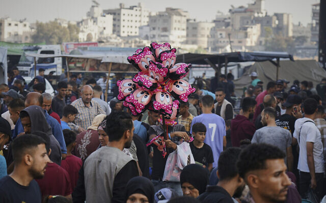 Palestinians walk trough a market ahead of the Muslim holiday of Eid al-Adha, in Gaza City, June 5, 2025. (AP Photo/Jehad Alshrafi)