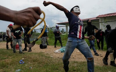 Anti-government protesters clash with police at the Indigenous Embera community of Arimae, Panama, Thursday, June 5, 2025. (AP Photo/Matias Delacroix)