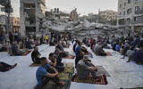 Palestinians gather for Eid al-Adha prayers beside the ruins of a mosque in Deir el-Balah, Gaza, June 6, 2025. (AP Photo/Abdel Kareem Hana)