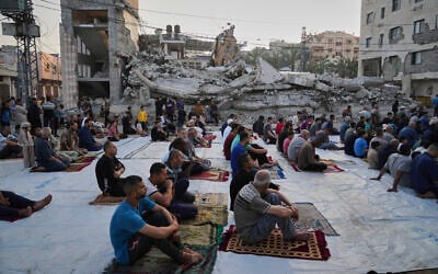 Palestinians gather for Eid al-Adha prayers beside the ruins of a mosque in Deir el-Balah, Gaza, June 6, 2025. (AP Photo/Abdel Kareem Hana)