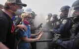 Protesters confront police on the 101 Freeway near the Metropolitan Detention Center of downtown Los Angeles, June 8, 2025. (Jae C. Hong/AP)