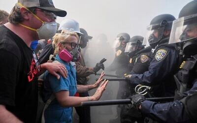 Protesters confront police on the 101 Freeway near the Metropolitan Detention Center of downtown Los Angeles, June 8, 2025. (Jae C. Hong/AP)